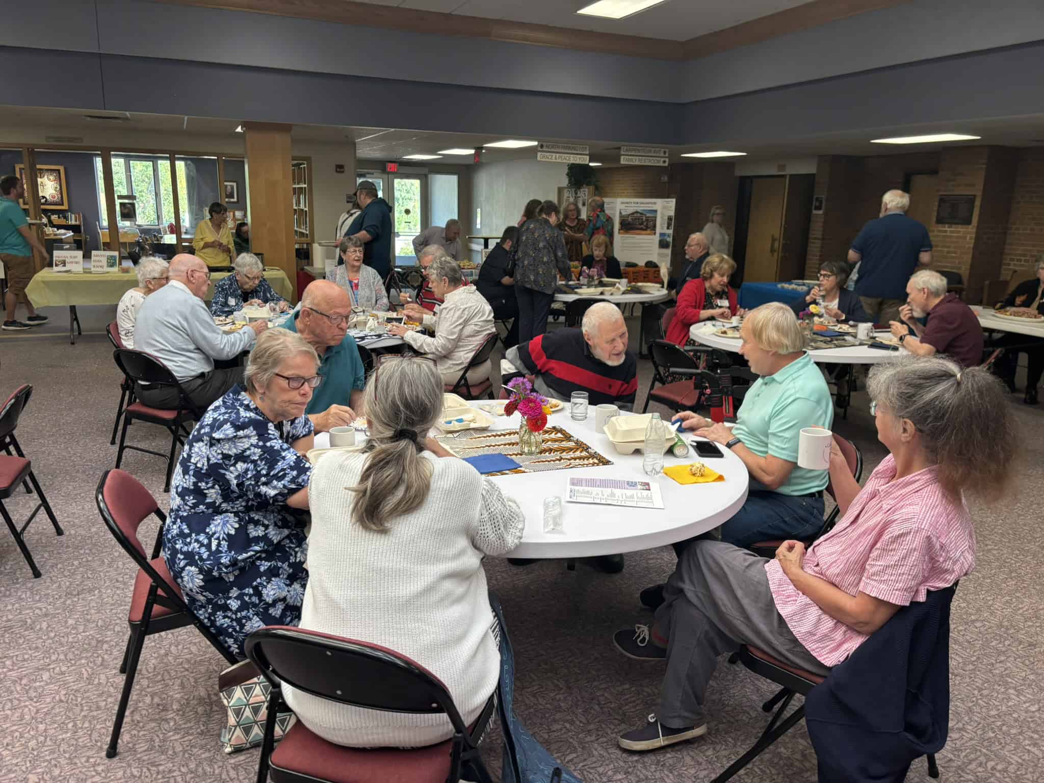 Group of diverse people smiling and enjoying a bowling game at Gustavus Adolphus Lutheran Church event.